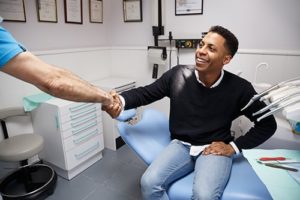 man shaking hands with dentist about medical practice management